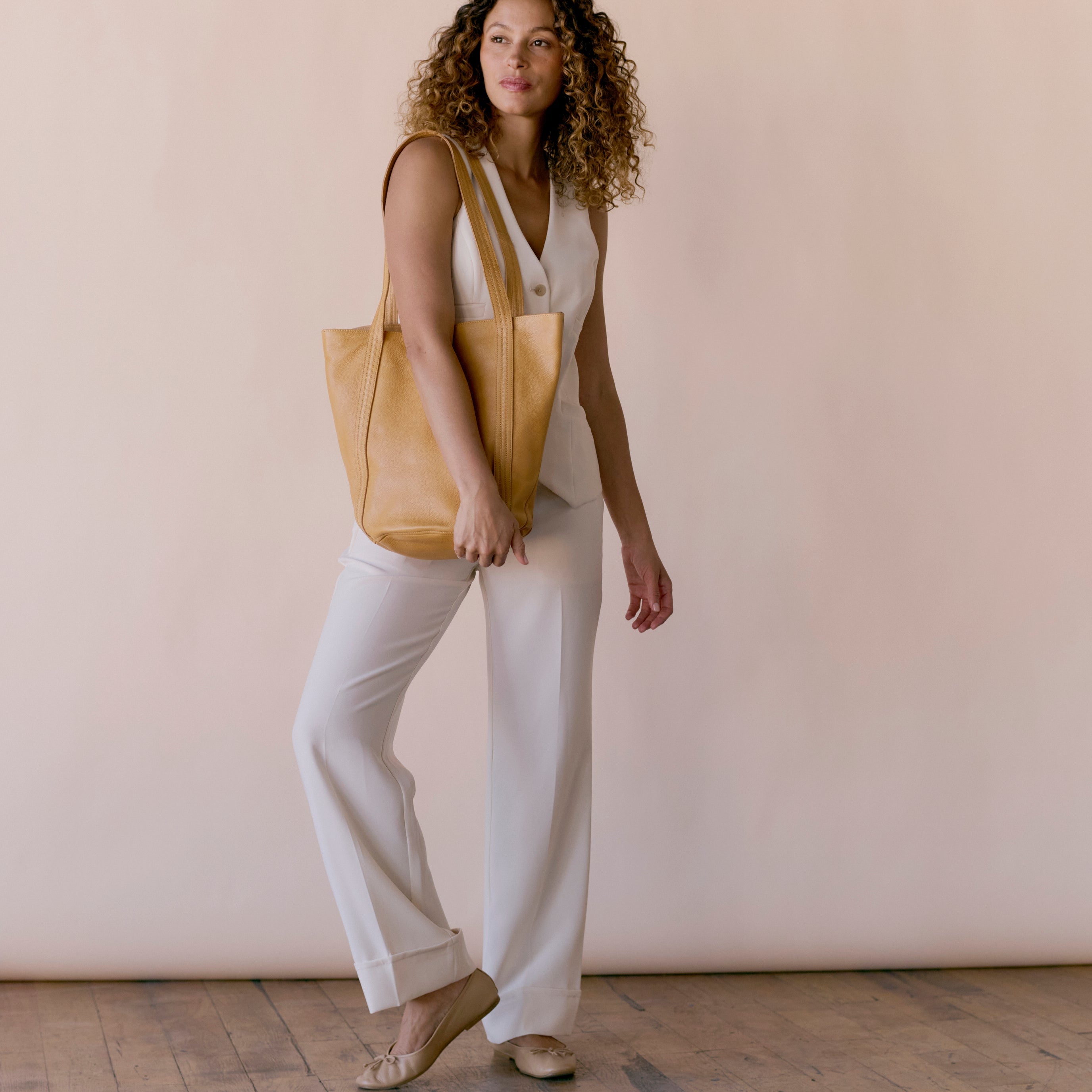 Camel full-grain leather Kent tote bag on model by Latico Leathers