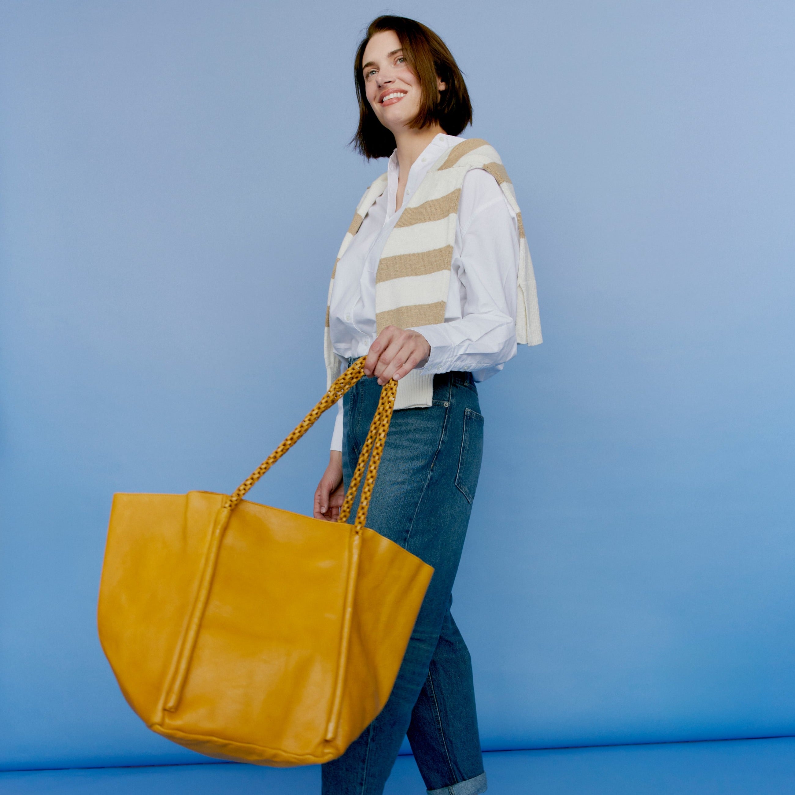 Mustard full-grain leather Voyage Lg tote bag on model by Latico Leathers
