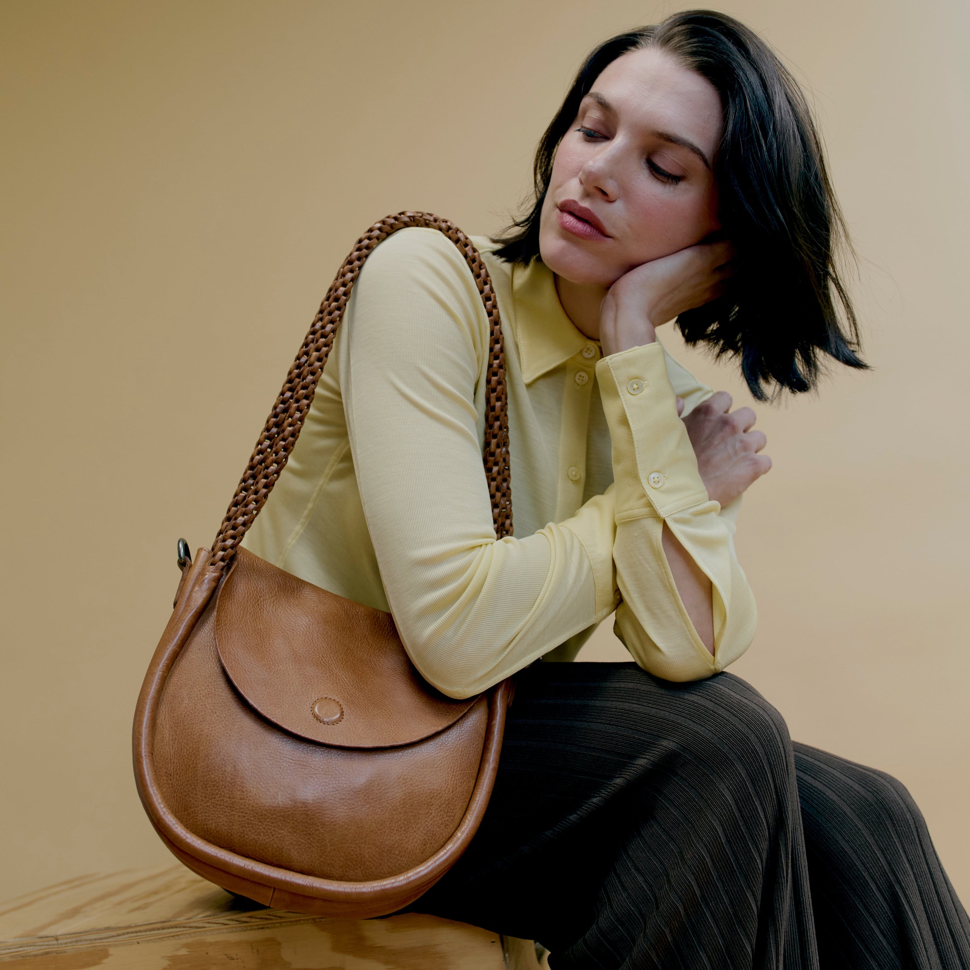 Cognac full-grain leather Portage crossbody shoulder bag on model by Latico Leathers