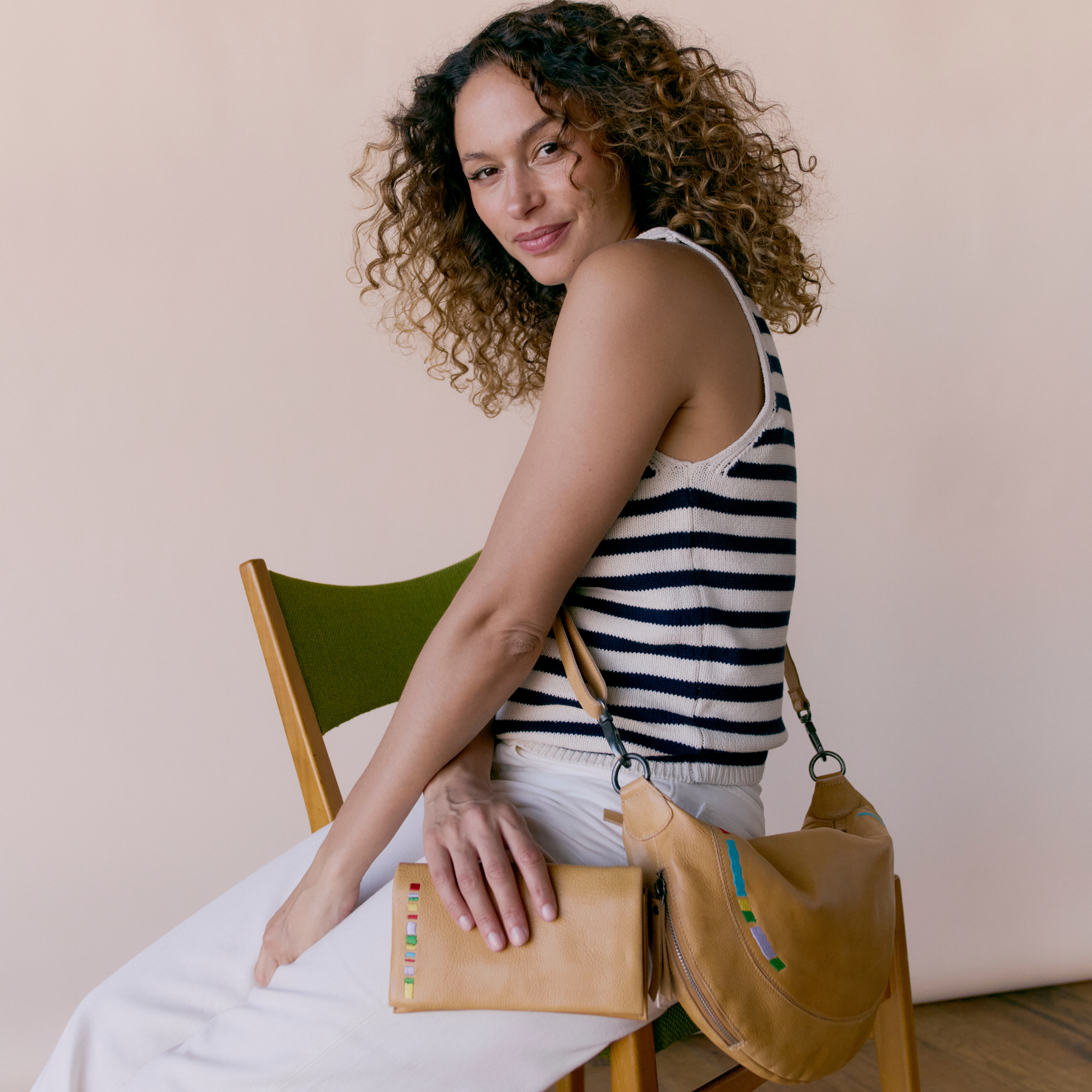 Camel full-grain leather Haven sling crossbody bag on model by Latico Leathers