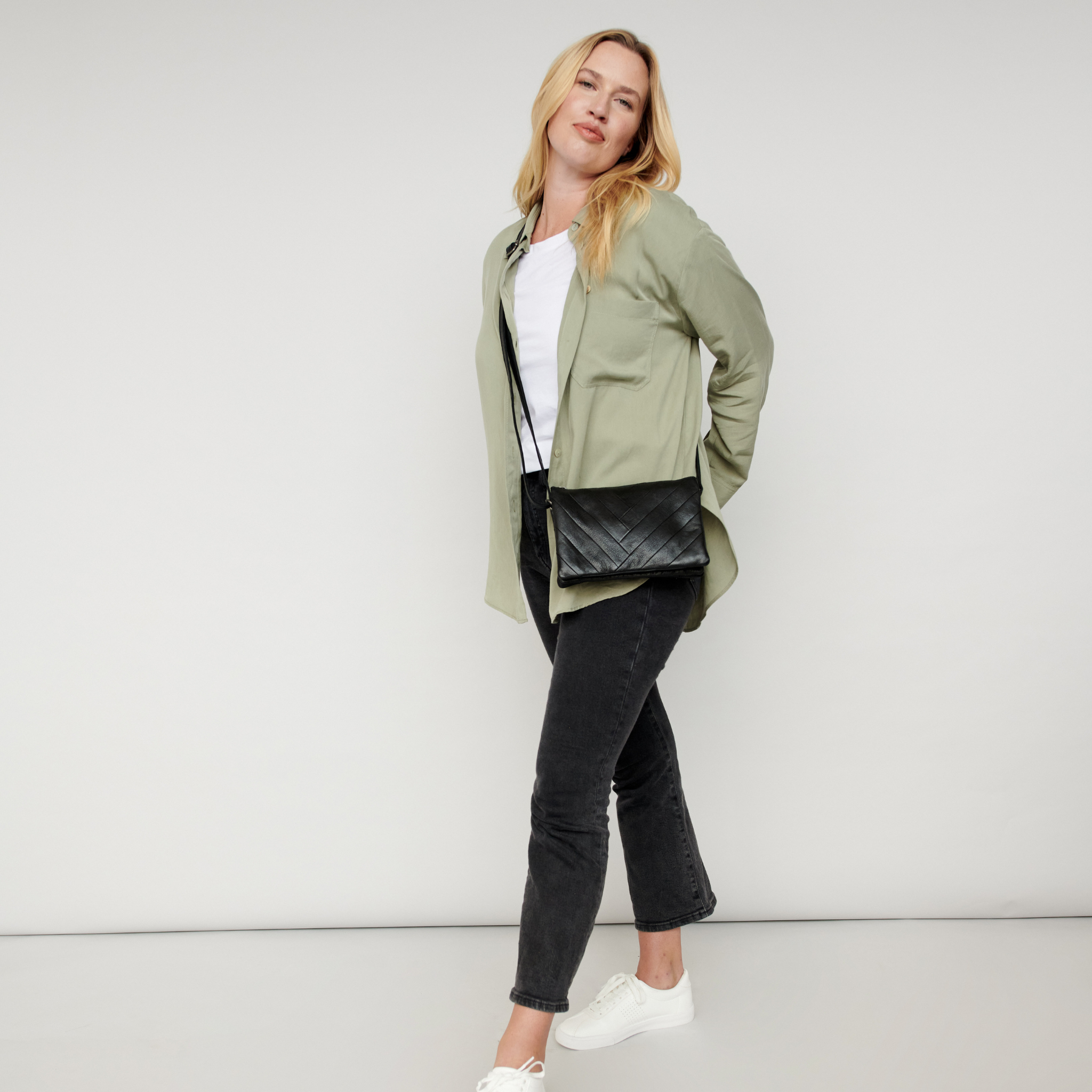 Black full-grain leather Sunny crossbody bag on model by Latico Leathers
